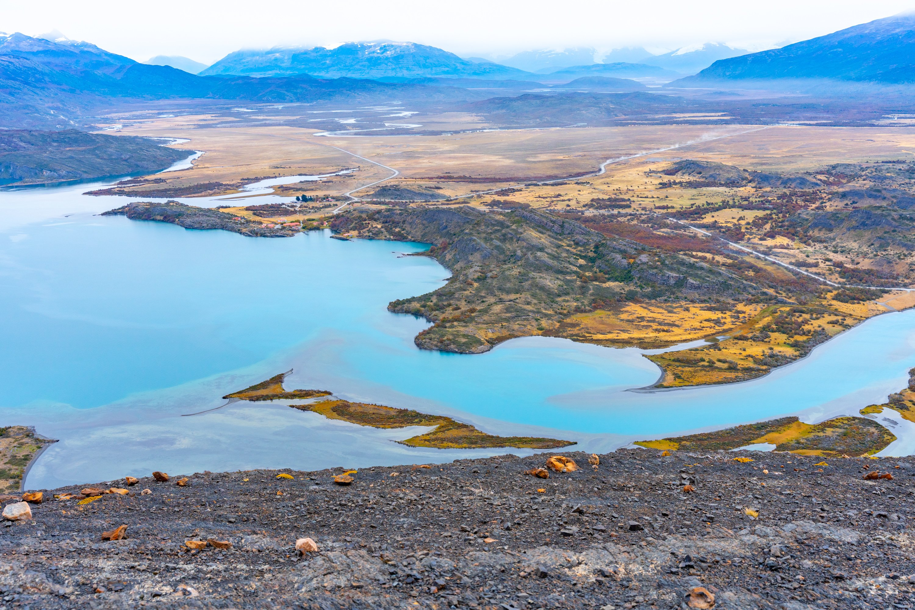 La impresionante vista desde el mirador final de la excursión, mostrando el Macizo Paine a lo lejos, el inmenso Lago Toro abajo y las pampas patagónicas extendiéndose hasta el horizonte.
