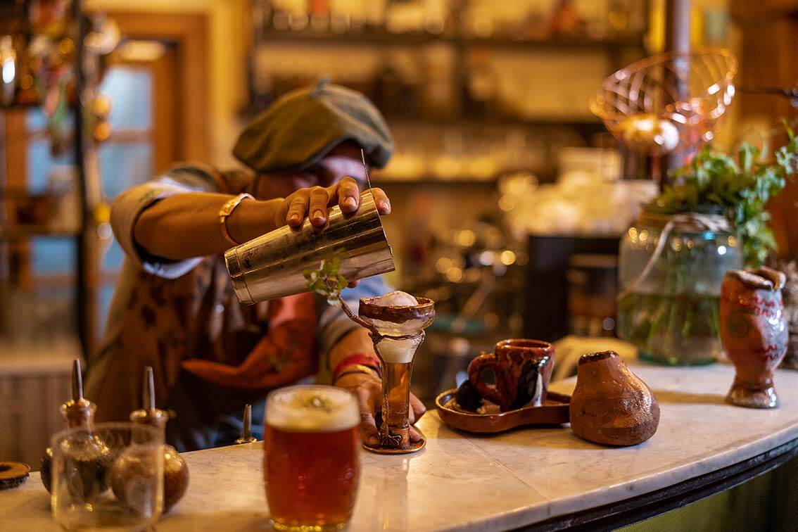 Pionero Bar at Hotel Las Torres serving craft cocktails and regional drinks in a cozy setting—perfect for relaxing after a day of hiking in Torres del Paine National Park.